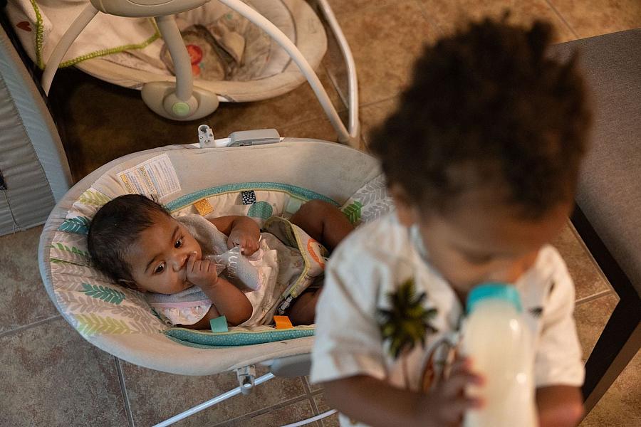 Two children, one drinking milk