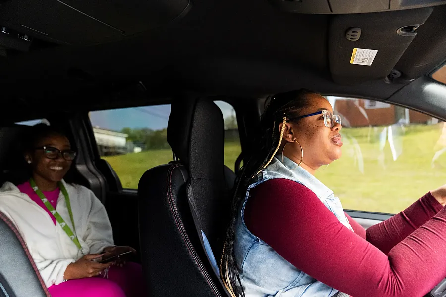 Person driving a car with a passenger 