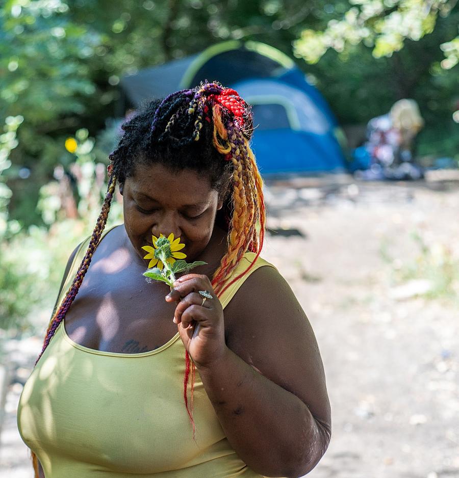 person smelling a flower