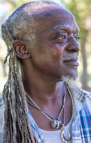 Person with blue shirt and white hair
