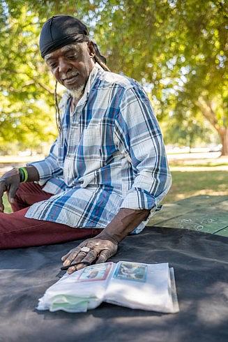 Person with blue shirt and black bandana