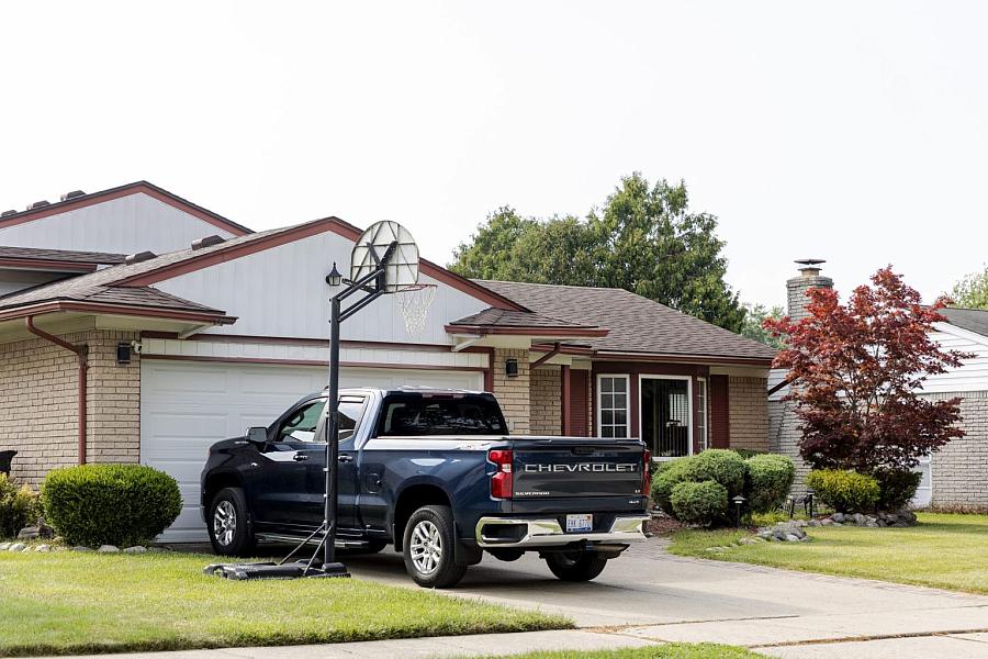 A house backyard with a car in it