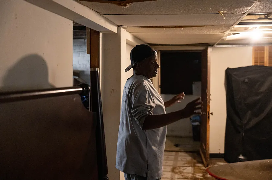 Andre Moseley describes the water damage in his Austin basement