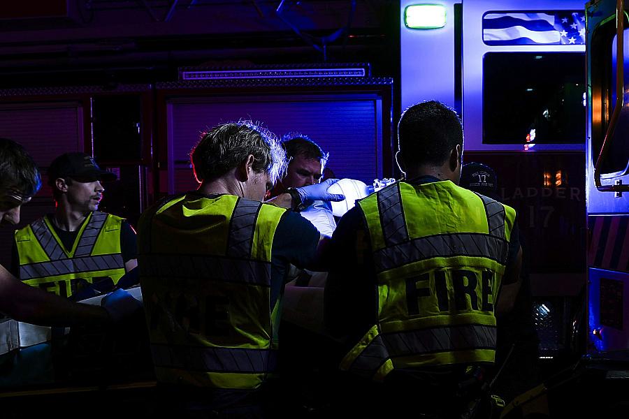 Image of paramedics and firefighters saving victim