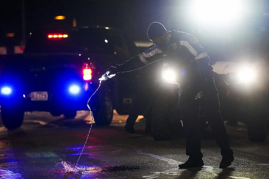 Image of a person throwing water on street