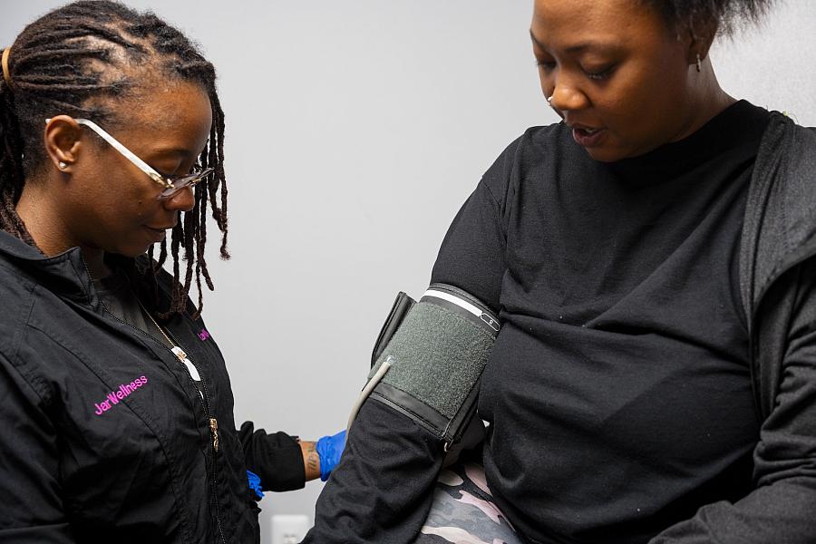 Person checking another person's blood pressure