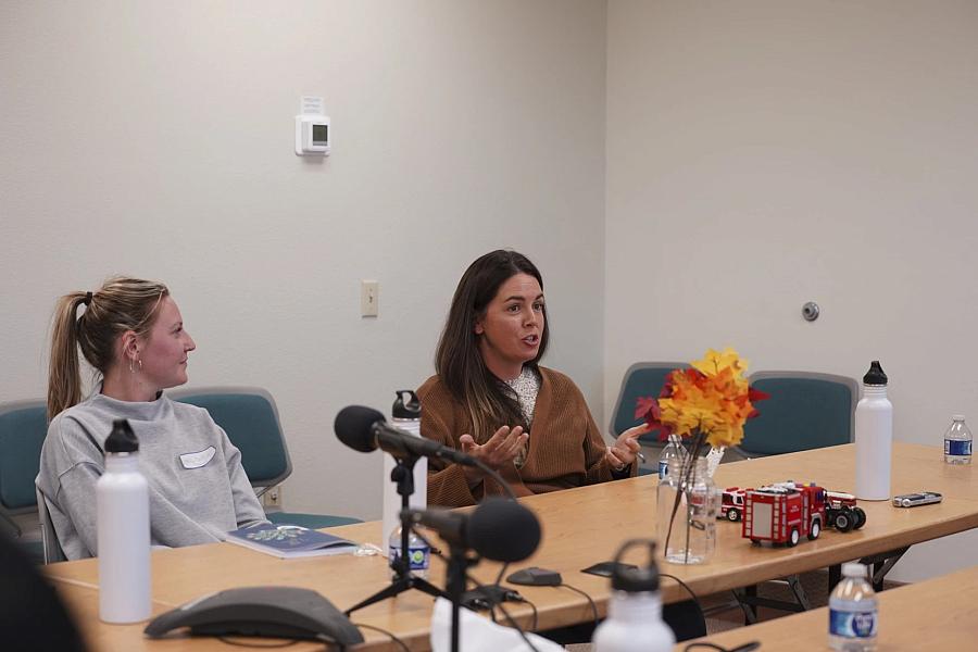 Image of two people speaking in mic