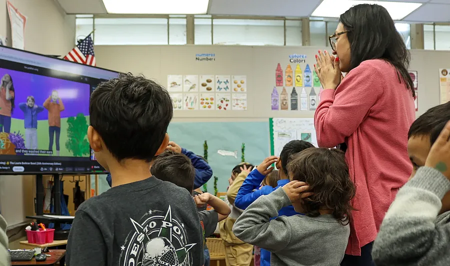 A teacher watching animation with children