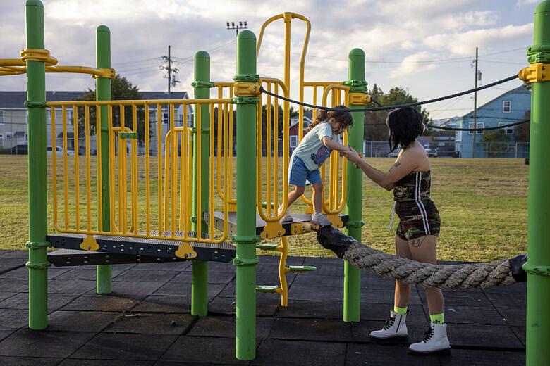 A person playing with child in a park