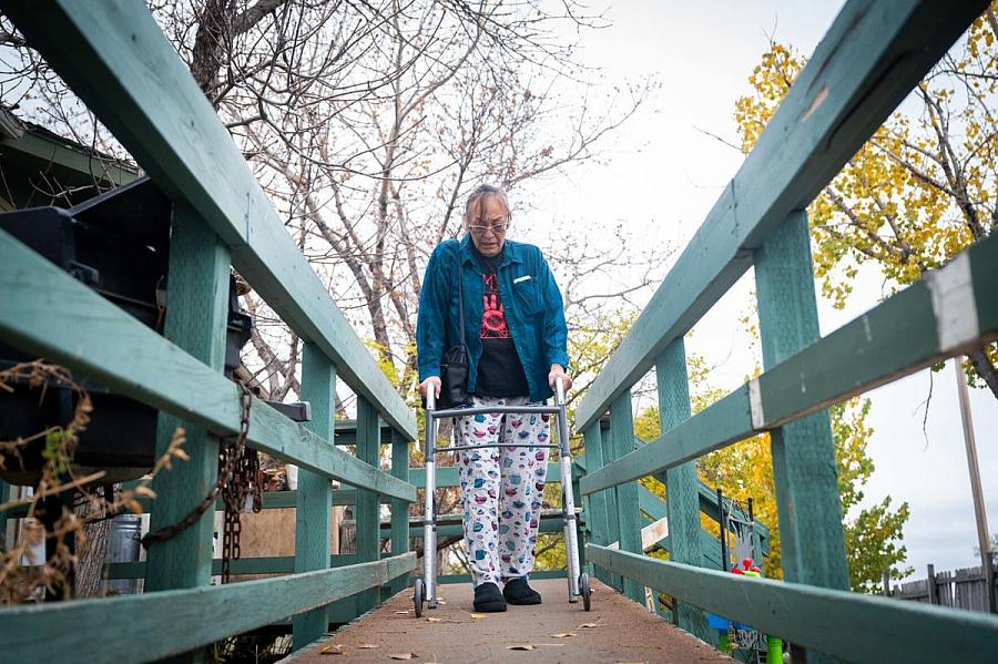 Person waking on bridge using a walker