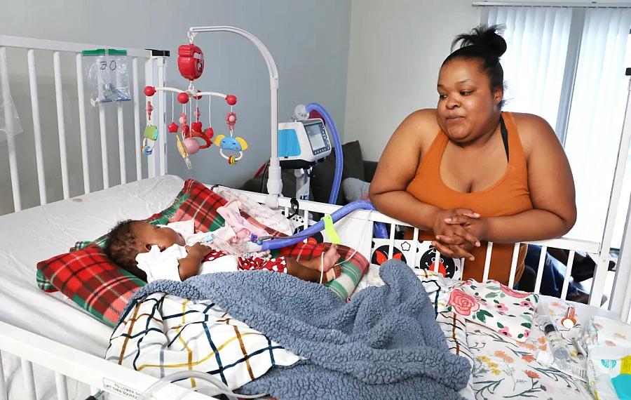 Person looking at baby in a crib