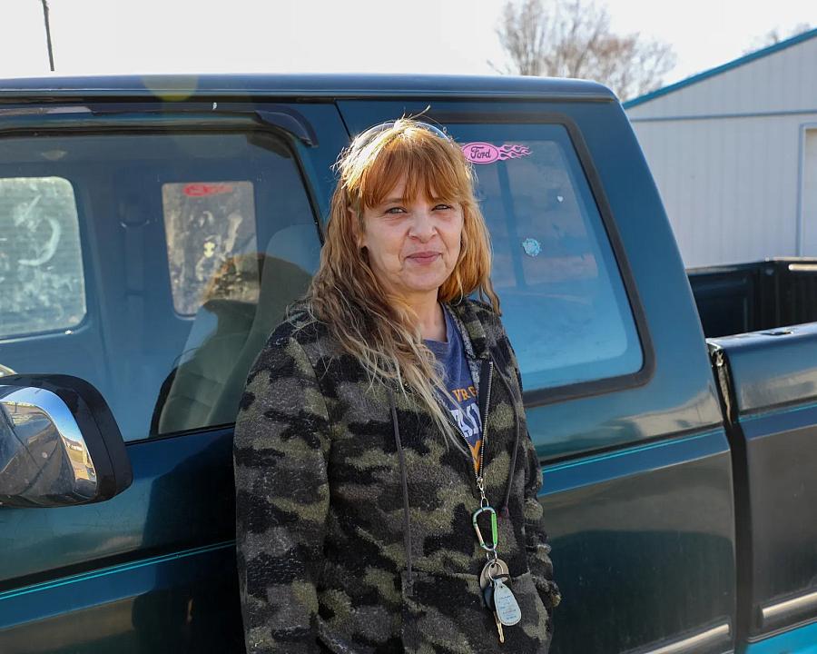 Person standing by a pickup truck