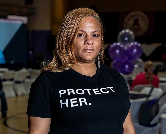 Image of a person wearing a t-shirt that says "Protect Her"