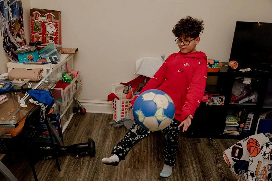 Kid showing his soccer skills in his room