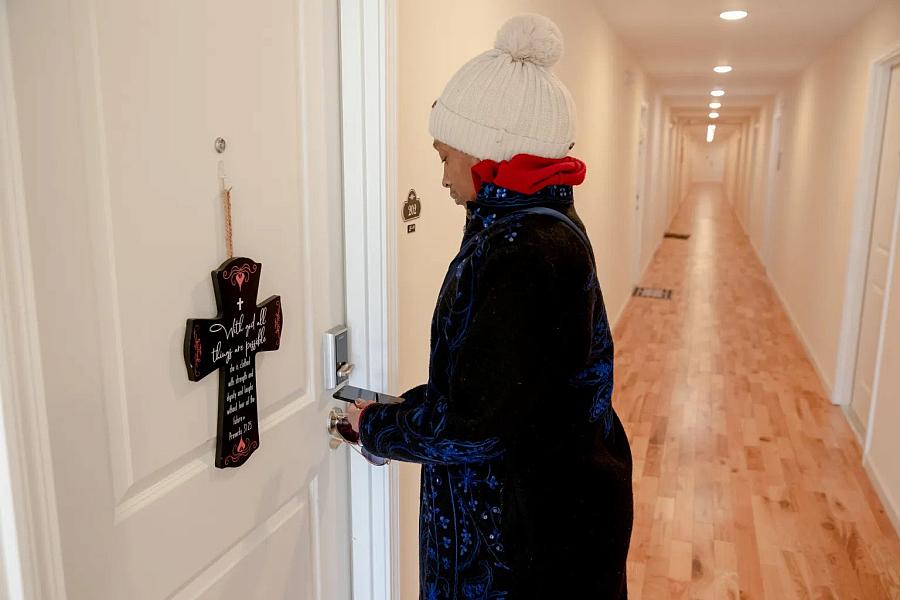 A woman opening her house's door