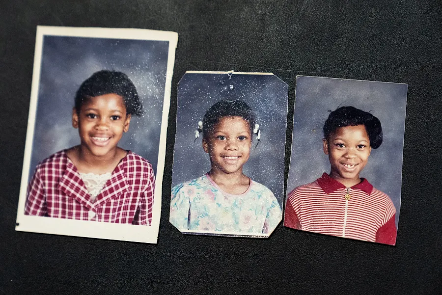 Three smiling school portraits of young girls side by side.
