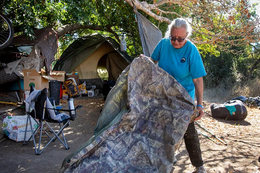 Person wrapping up an encampment