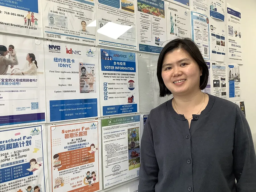 Person standing in front of a informative board