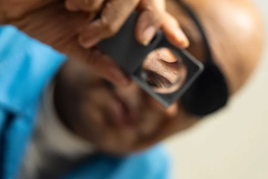 A person using magnifying glass