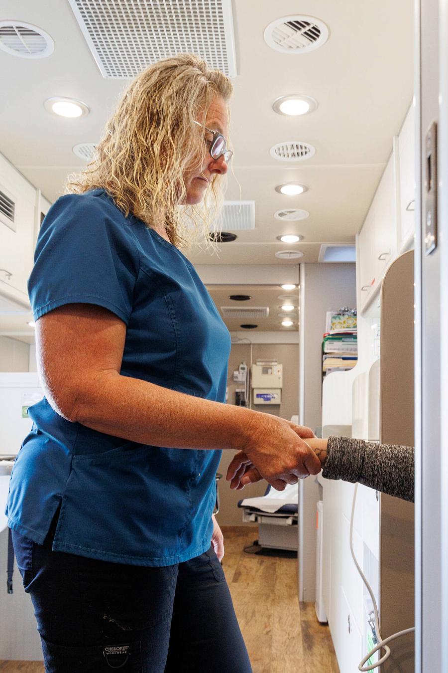 Image of a healthcare worker checking blood pressure of a patient