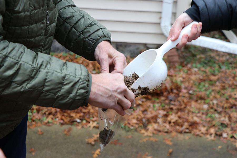 Person putting soil into a bag
