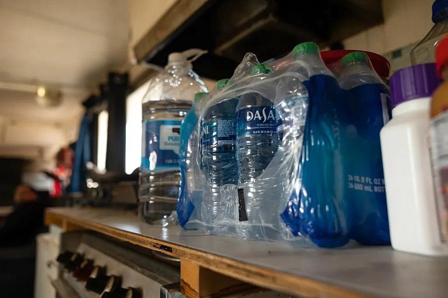 Image of bottled water on kitchen counter.