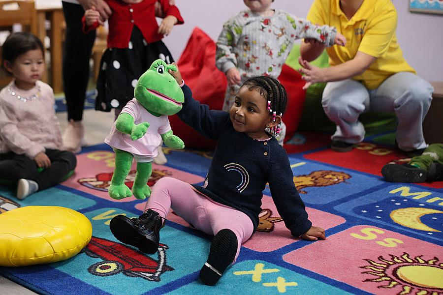 A child playing with a soft toy