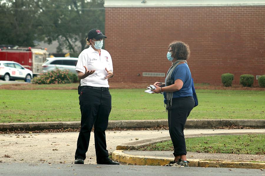 Jen Christensen interviewing someone in the field.