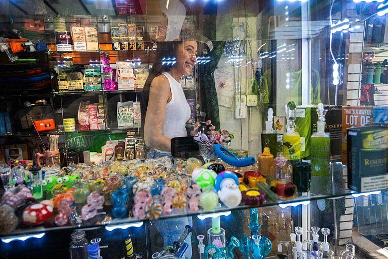 Image of a person through the glass wall of a shop.