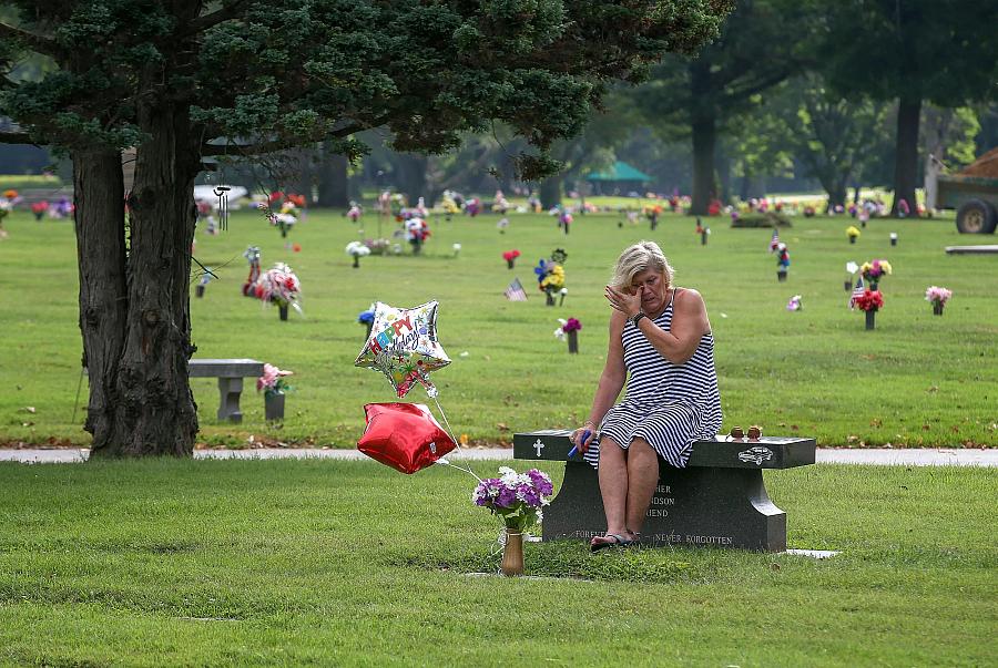 Mother on her son's grave on his birthday