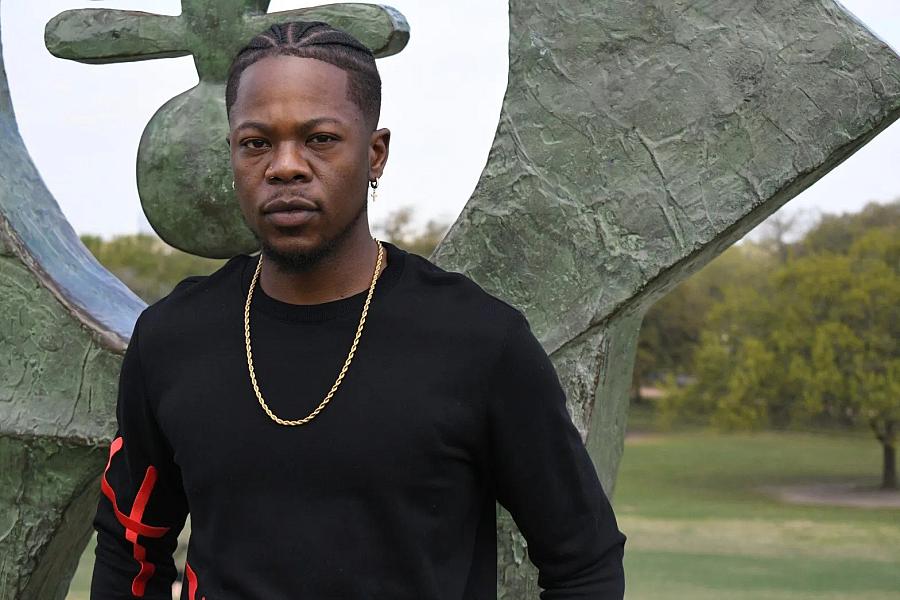 Kahlib Barton, 32, poses for a photo at Hermann Park in Houston on Feb. 25, 2023. During high school, Barton says they were criminalized and adultified as a Black teenager. (Aswad Walker/Word In Black)