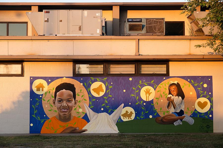 Image of a mural on the wall with two children playing