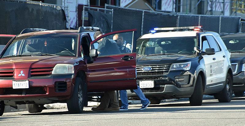 Image of cops pulling a red car