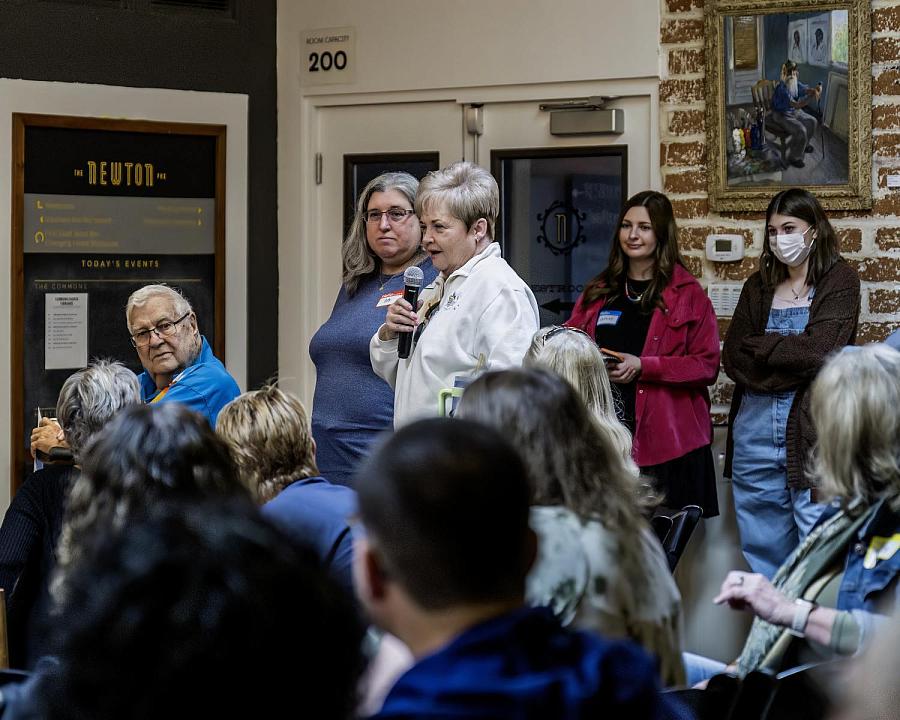 Person in audience speaking at an event