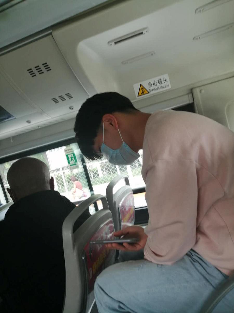 Image of a person wearing a mask in bus