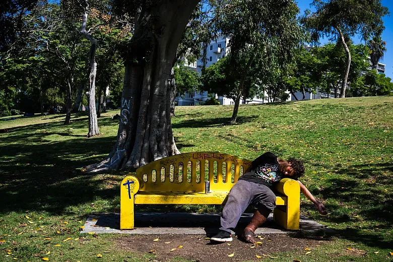 Image of a person sleeping on park bench