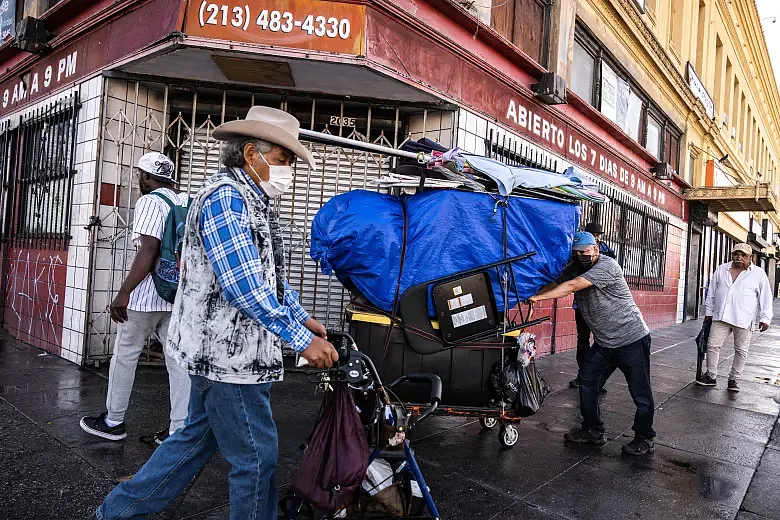 Image of a person carrying trolley on the streets