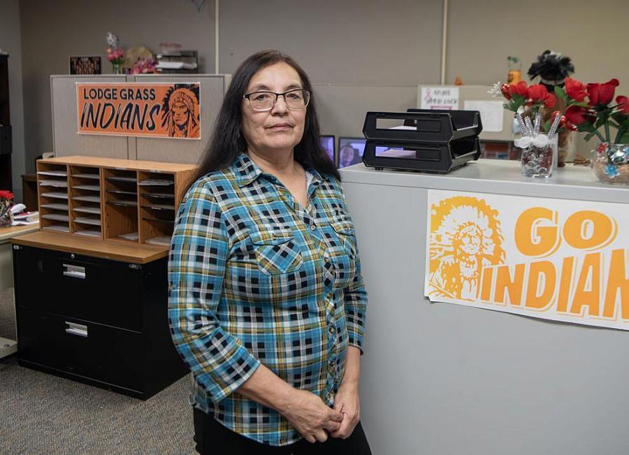 Image of a person standing near the poster of Go Indians