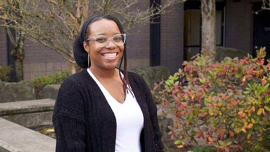 Person in black suit and white dress with spectacles