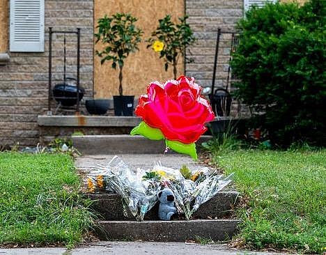 Balloons and flowers outside a home