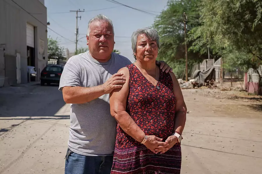 Image of two people posing for camera