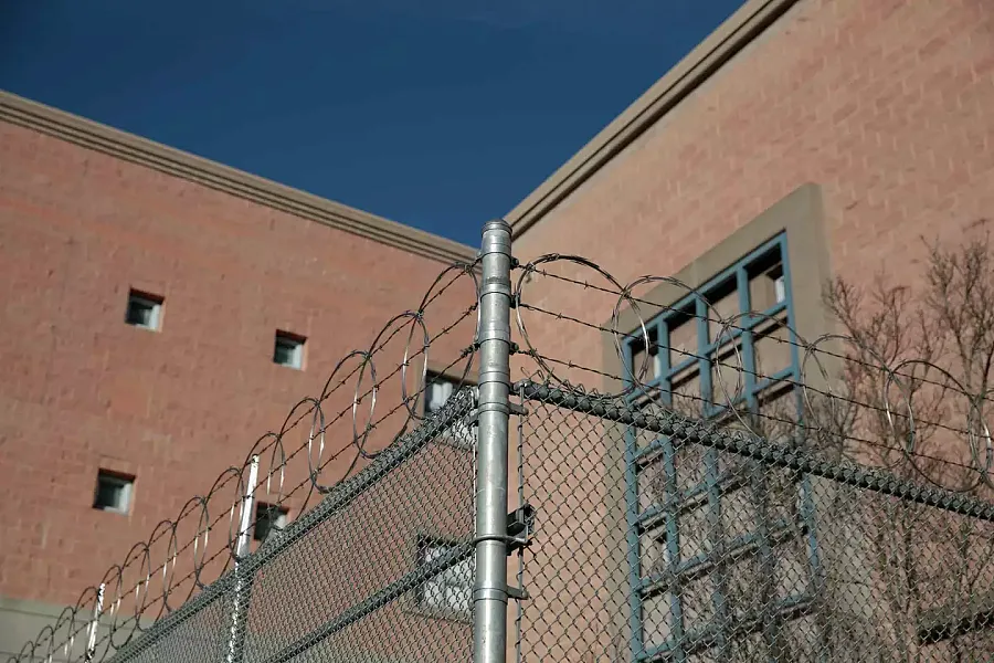 Image of a fenced wall of detention center