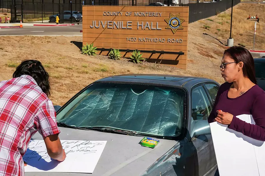 Image of a two people making signs for the protest