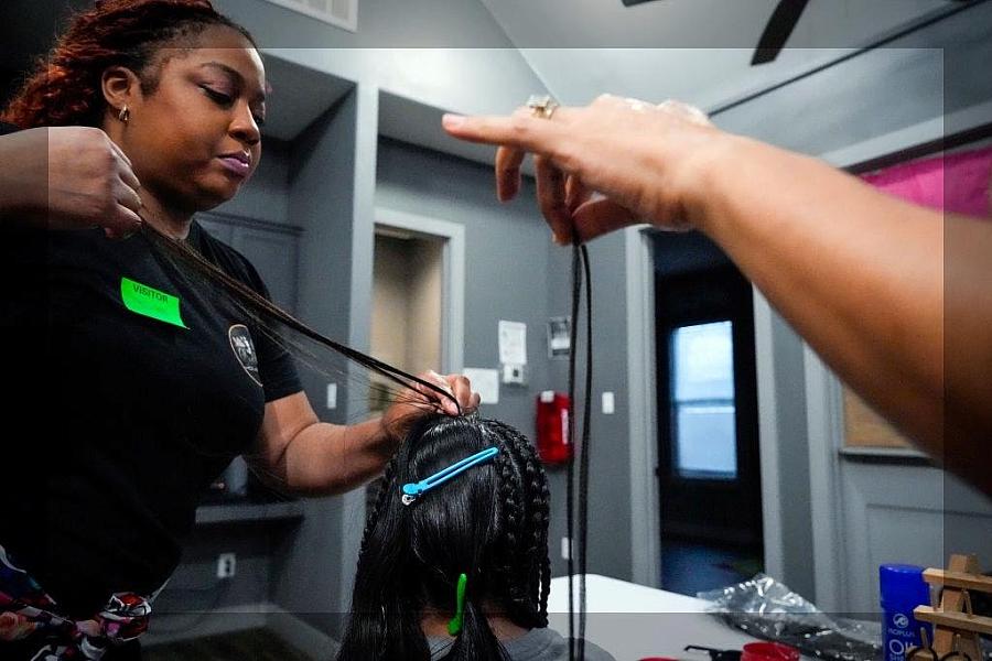 A person working on someones hair