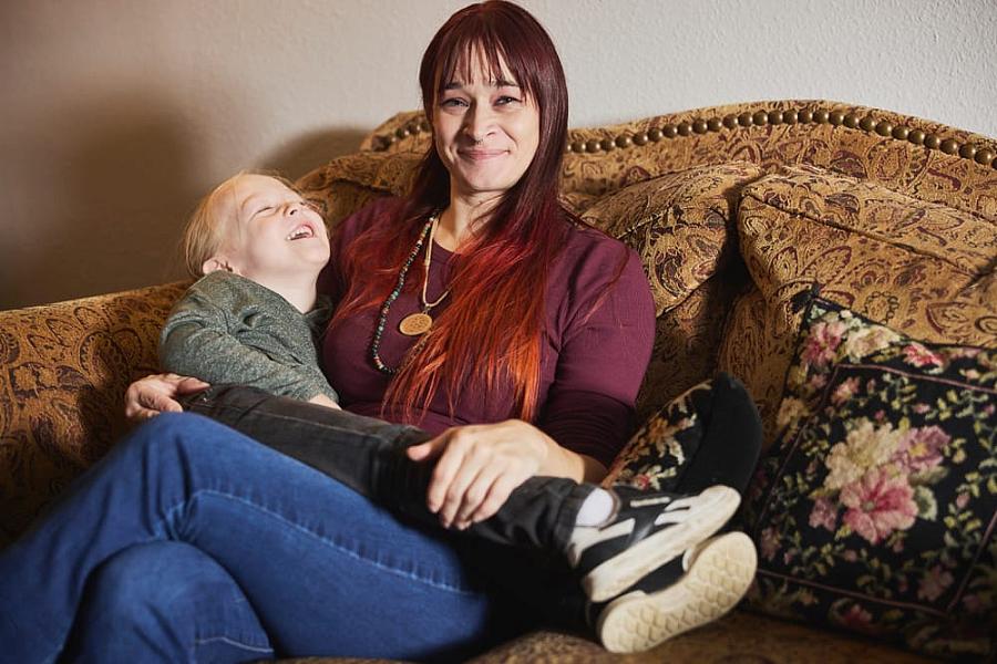 A person with a child on lap