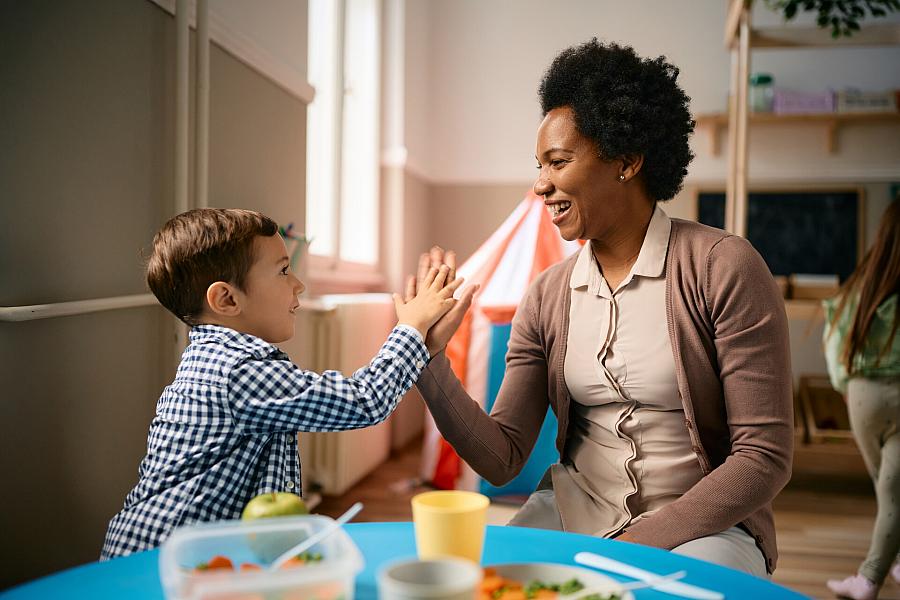 A teacher with kindergarten child.