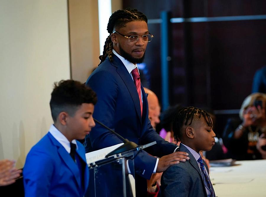 Buffalo Bills safety Damar Hamlin, center, at an event with Rep. Sheila Cherfilus-McCormick, D-Fla., in Washington, D.C., on March 29, 2023. Cherfilus-McCormick introduced a bill to help provide money to schools for AEDs. Hamlin introduced his younger brother and cousin during the event.