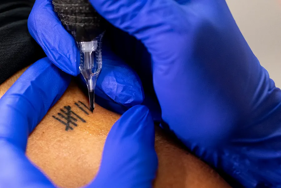 A person adding a tattoo