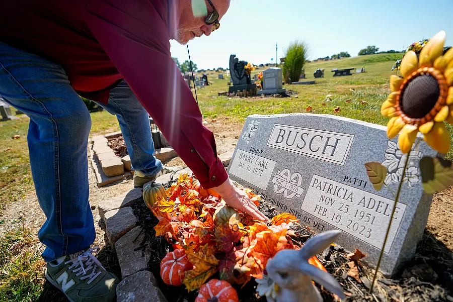 A person paying respects at a toumb