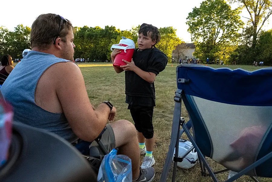 A person taking a break during football practice 